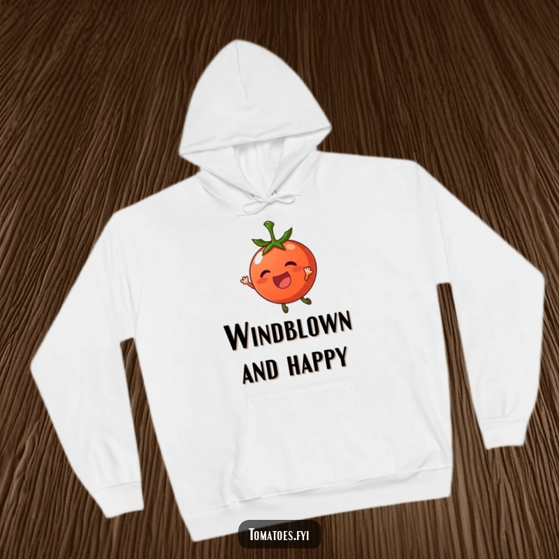 Funny hoodie with a thrilled tomato character being carried by a gentle breeze, cozy and whimsical apparel.