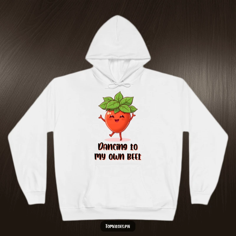 Funny hoodie depicting a cheerful tomato character, adorned with a miniature leaf hat, dancing with uninhibited glee and a broad smile.
