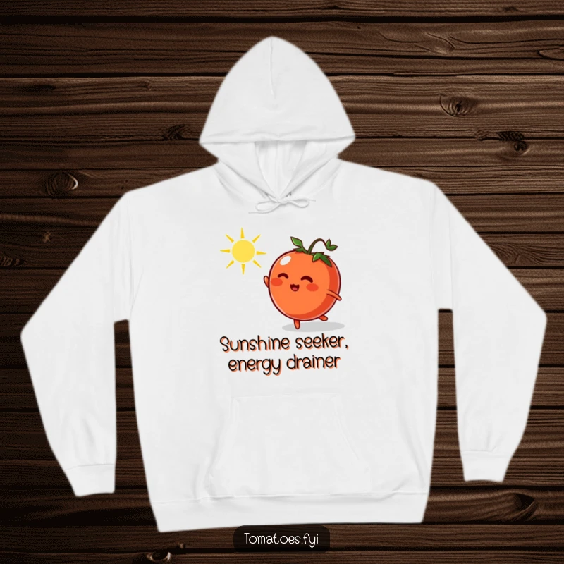 Funny hoodie showing a cheerful cartoon tomato energetically chasing a radiant dancing sunbeam, perfect for cozy, humorous moments.