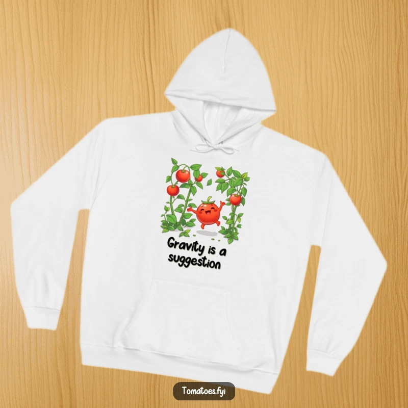 Funny hoodie featuring a joyful cartoon tomato doing a cartwheel amongst green plants, perfect for cozy, celebratory vibes.