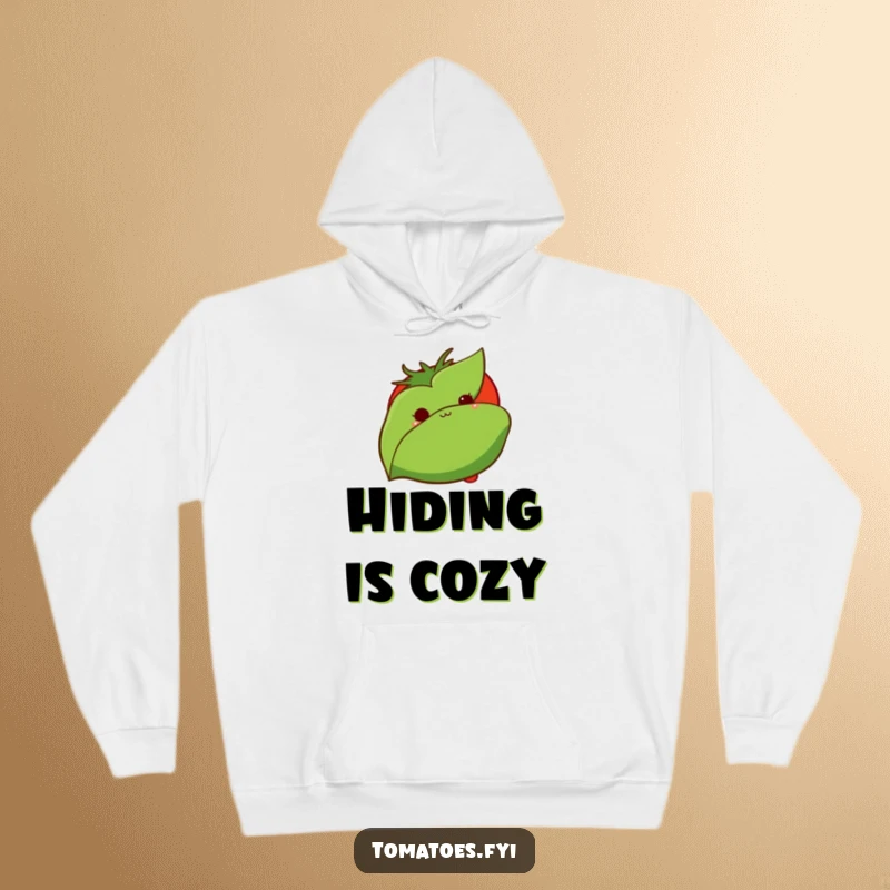 Funny hoodie shows a bashful tomato peeking from behind a green leaf, offering warmth and subtle humor for introverts.